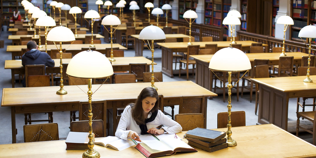 photo of a young female student studying in library